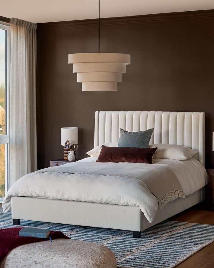 Amalfi Fabric Double Bed in ivory with vertical channel tufting on headboard, displayed in a styled bedroom setting.
