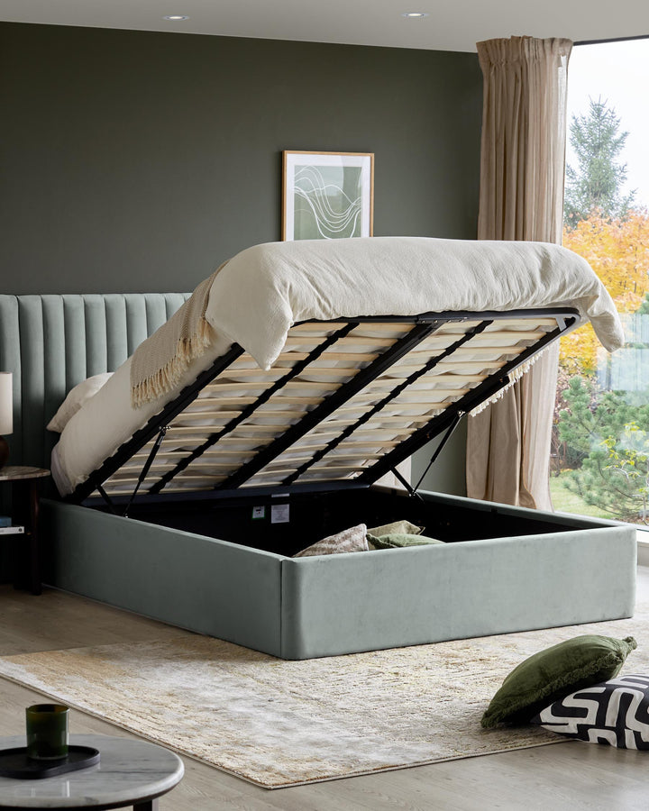 Upholstered ottoman bed with headboard tilted open to reveal storage space. Modern bedroom interior.