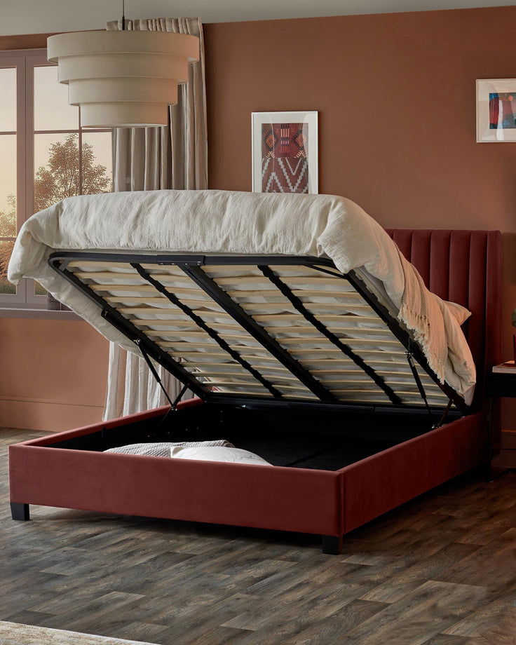 An upholstered storage bed frame in reddish-brown with the mattress lifted up to show storage space.