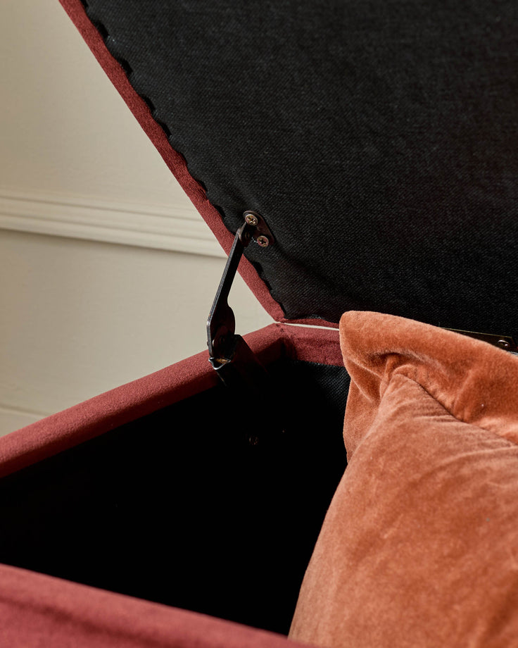 Toffee velvet ottoman bench detail showing open lid with metal handle and black interior storage compartment.