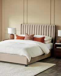 Bedroom featuring a stylish upholstered bed with headboard, bedside tables with lamps and a neutral rug.