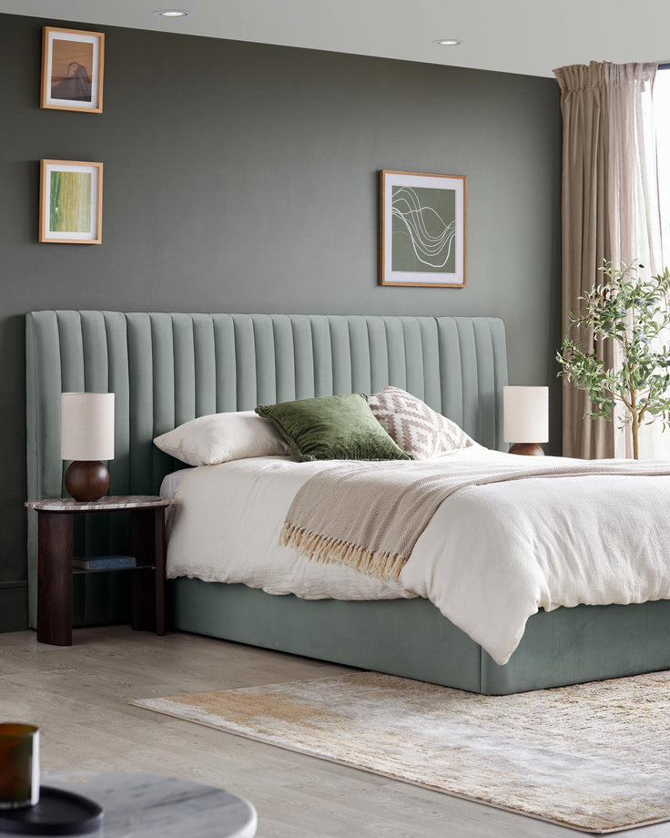 Bedroom featuring a plush bed with a tall headboard, side table, lamps, rug, and various decorations.