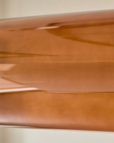Amber single pendant light with caramel glass, close-up detail shot showing smooth curved glass surface and glossy finish.