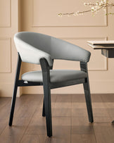 Amelia dining chair in light grey leather with dark wood frame, angled view showing curved backrest and seat.