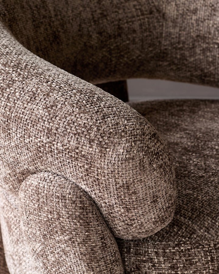 Anya accent chair in mocha fabric, close-up detail of textured weave and curved armrest.