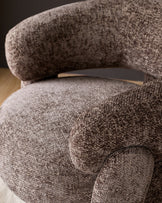 Anya accent chair in mocha fabric, close-up detail showing curved armrest and plush upholstery texture.
