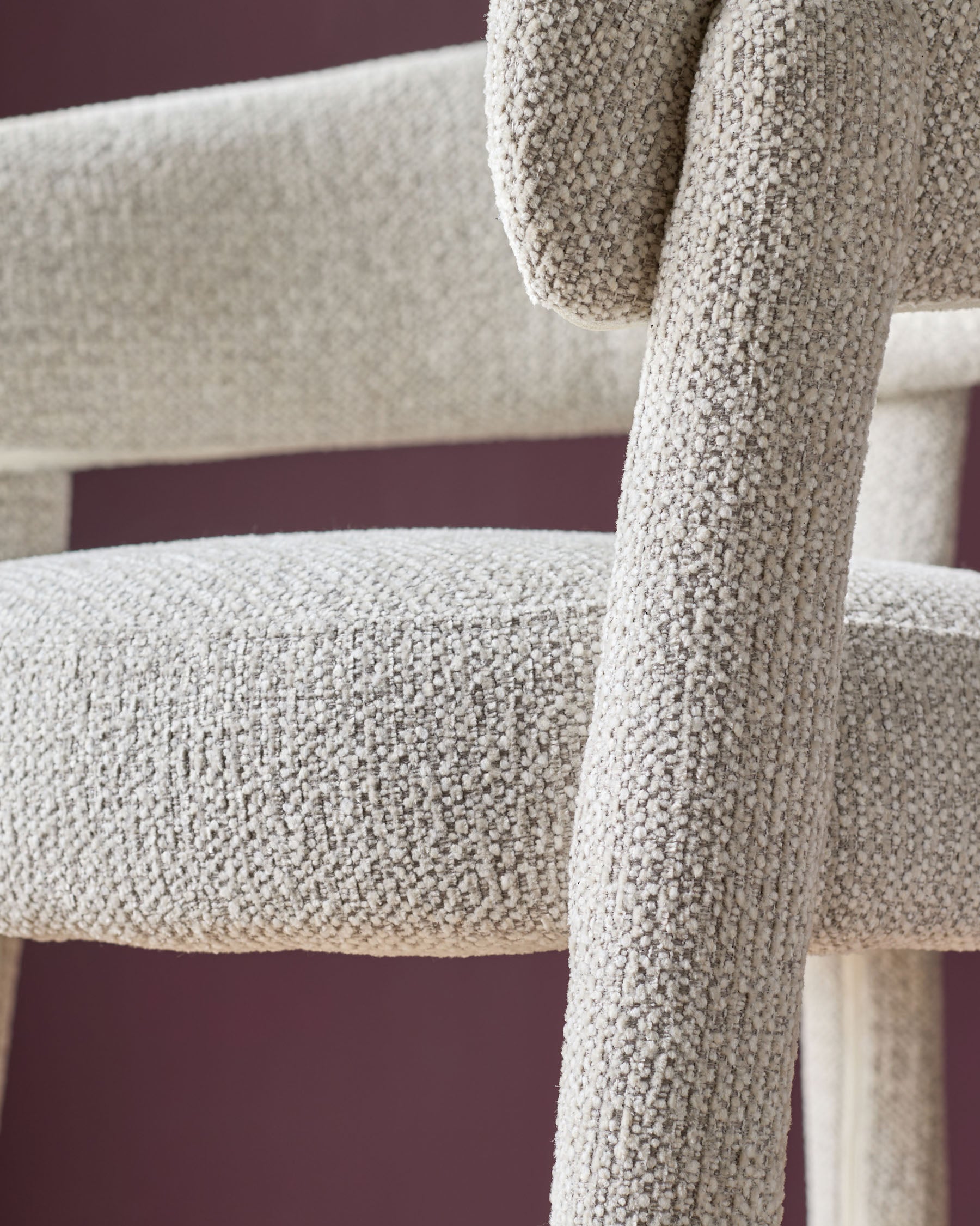 Anya bar stool in natural fabric, close-up detail showing textured weave and wooden leg structure.