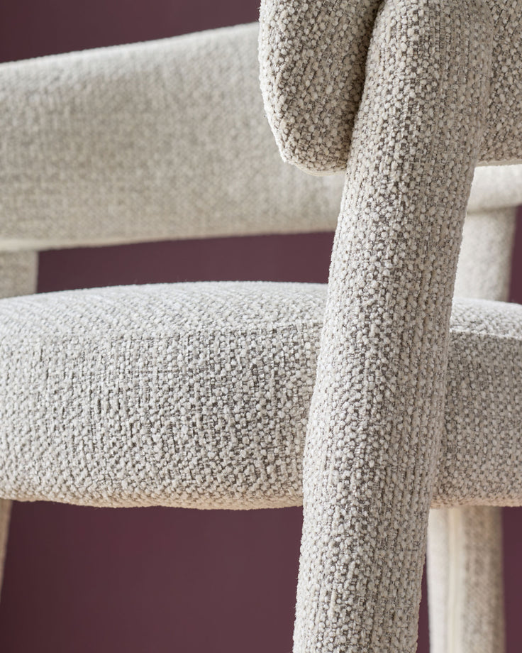 Anya bar stool in natural fabric, close-up detail showing textured weave and wooden leg structure.