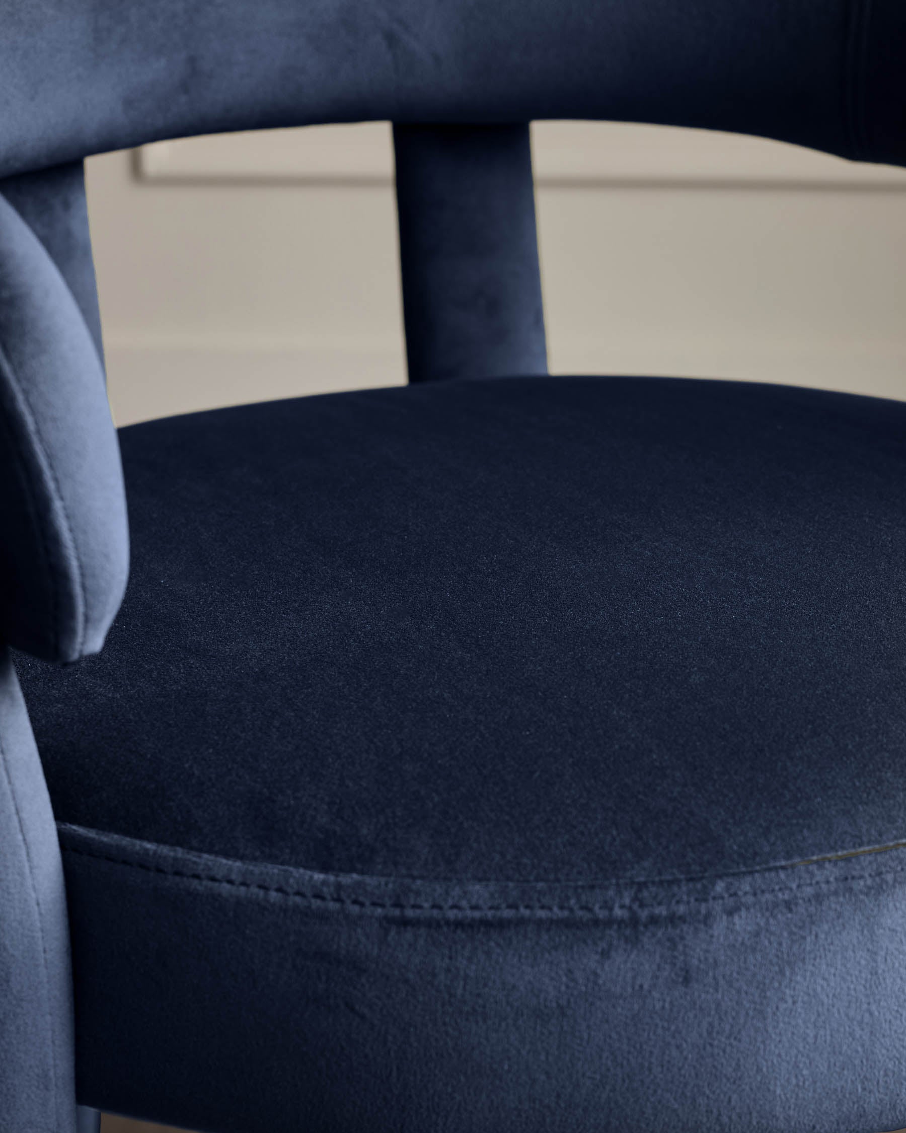 Close-up of a stylish blue velvet chair, showcasing the soft texture and elegant design. Perfect for a touch of luxury.