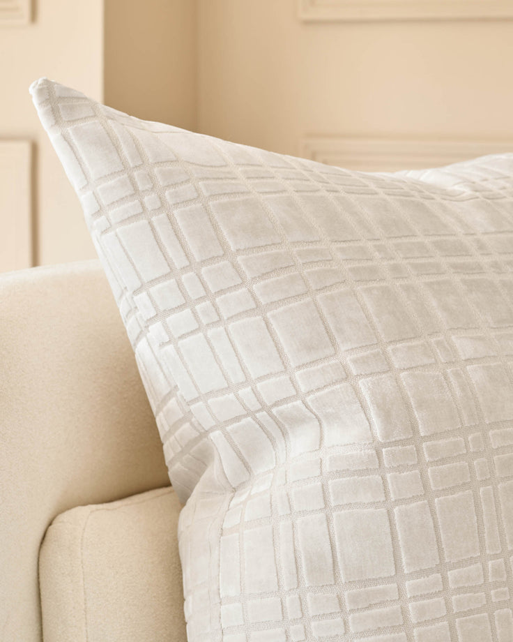 Arabella Large Ivory Cushion with geometric quilted pattern, displayed on a cream upholstered sofa.
