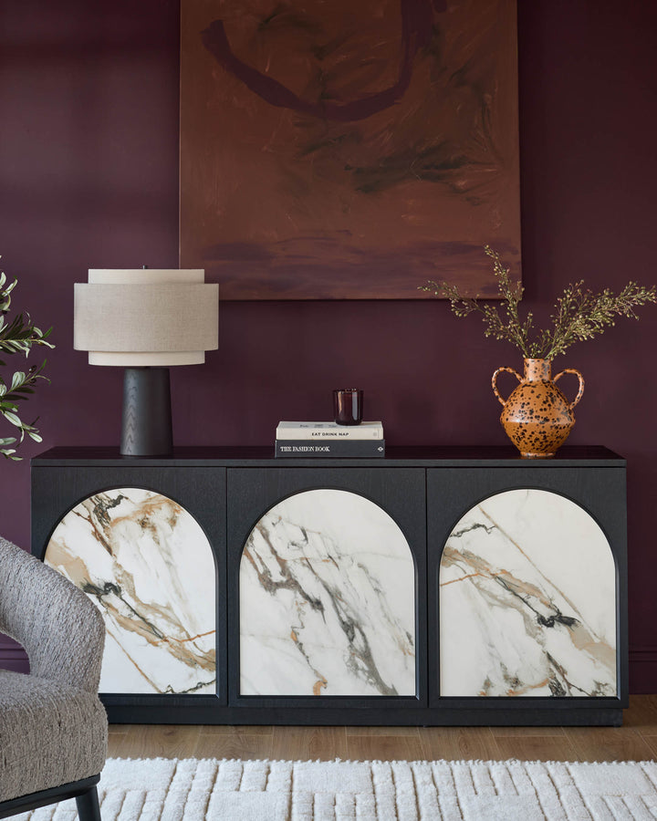 Archie Large Sideboard in black with three marble-fronted doors, displayed in a styled living room setting.