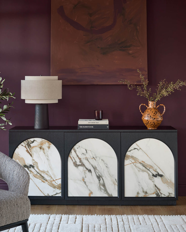 Archie Large Sideboard in black with three marble-fronted doors, displayed in a styled living room setting.