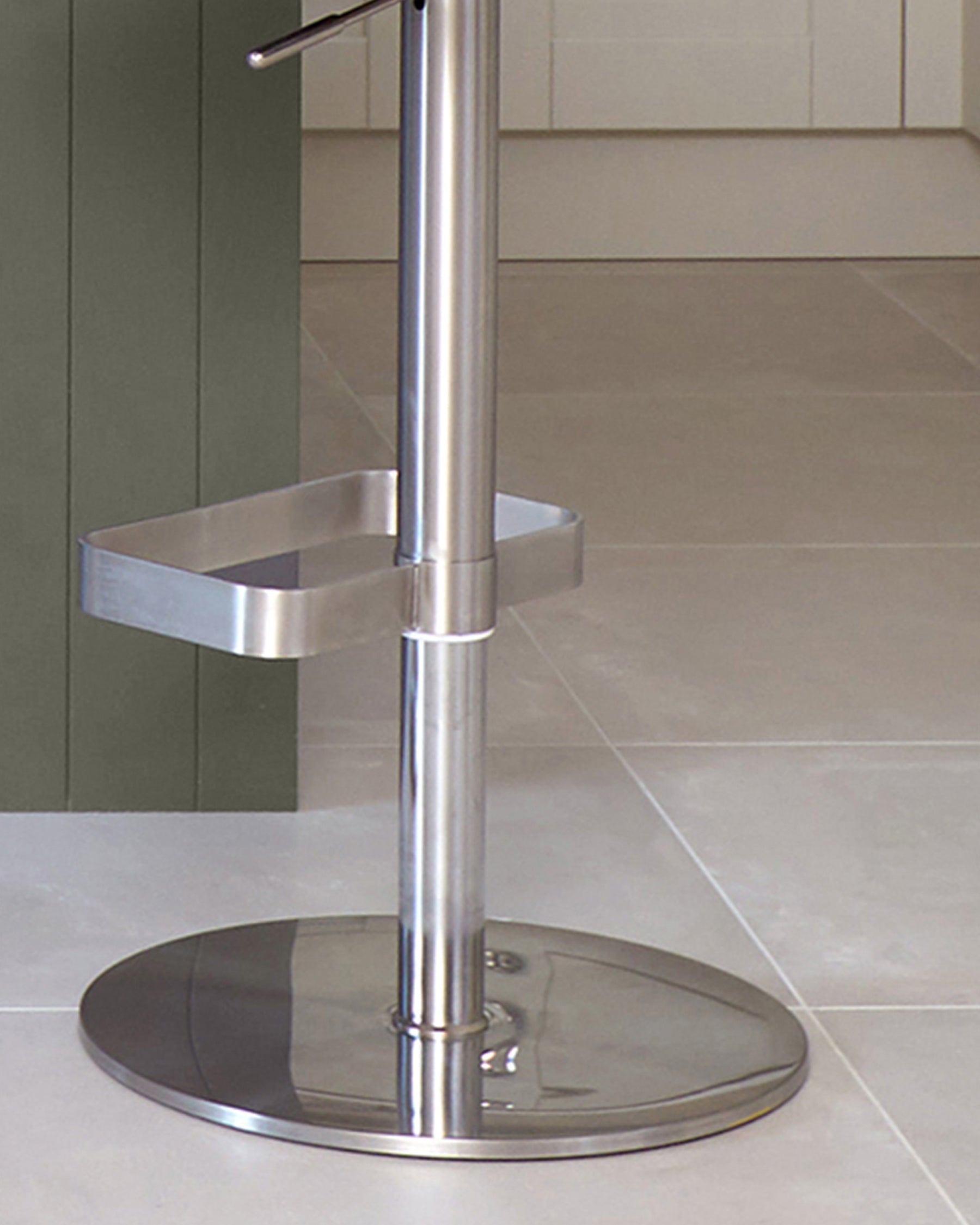 Brushed steel bar stool with a round base and a rectangular footrest.
