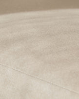 Cream fabric close-up showing soft woven texture and stitching detail on Asher dining chair