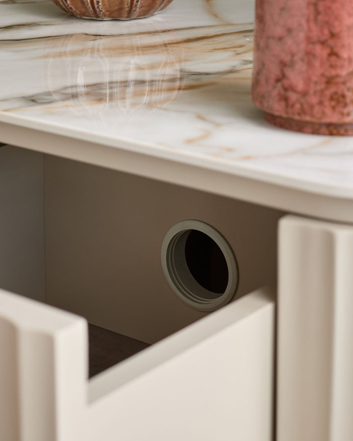 Austin bedside table in natural ceramic finish, showing round handle detail on drawer front.