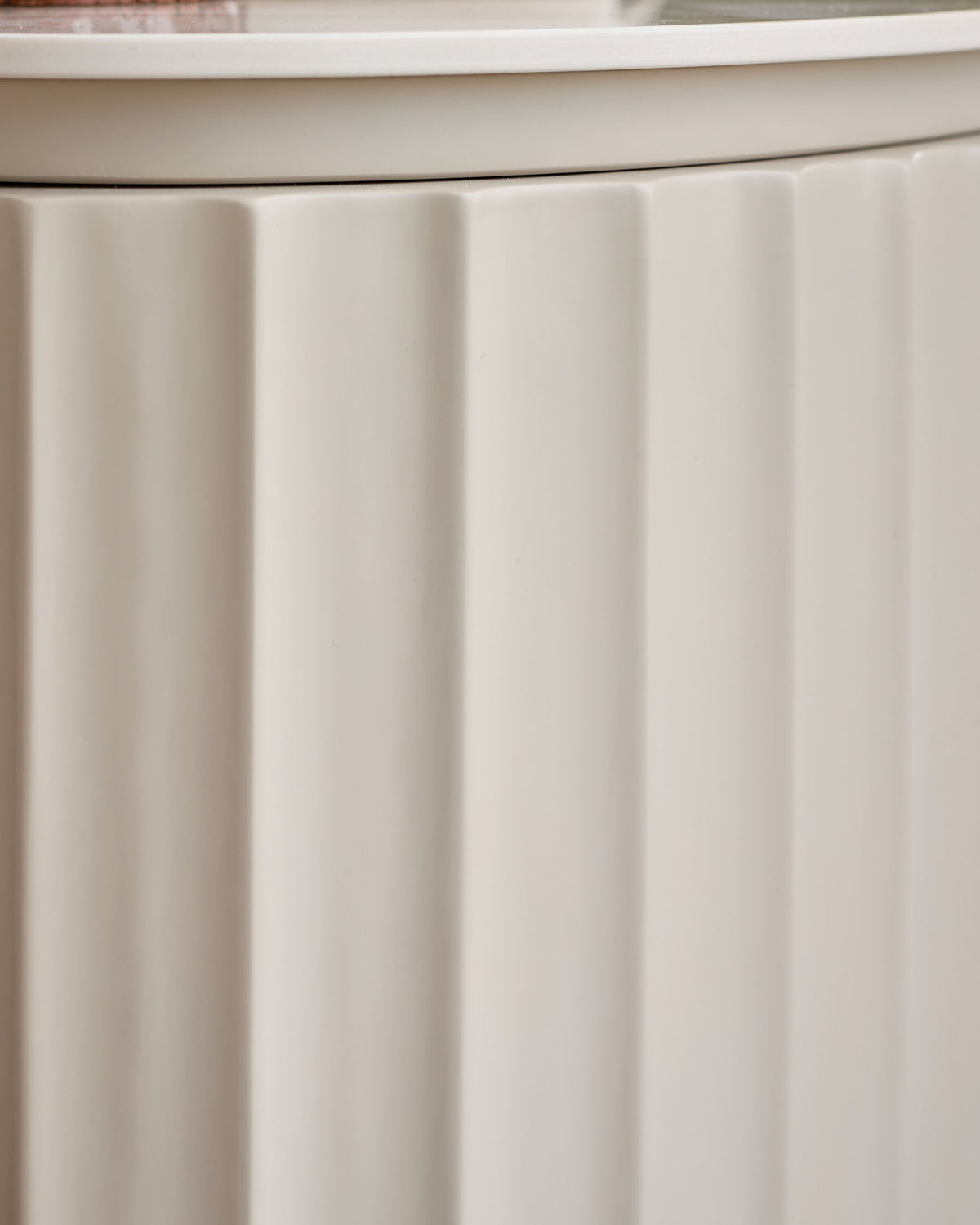Austin bedside table in natural ceramic with vertical ribbed paneling detail on front.