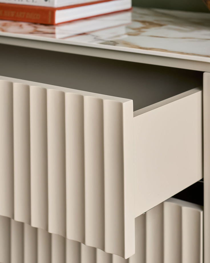 Austin chest of drawers in ceramic natural finish, showing open drawer with vertical ribbed detailing and grey interior.
