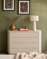 Austin chest of drawers in natural ceramic finish with vertical ribbed detailing and rounded edges, styled in a room setting.