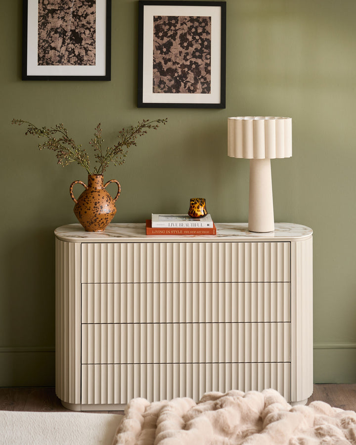 Austin chest of drawers in natural ceramic finish with vertical ribbed detailing and rounded edges, styled in a room setting.