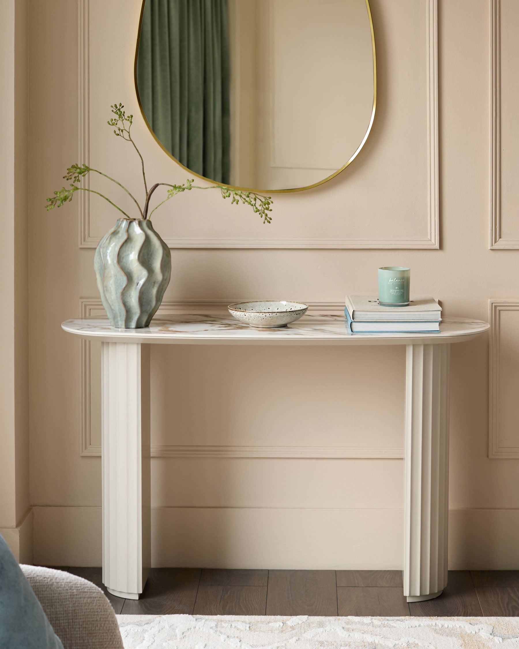 Austin ceramic console table in natural finish, oval shape with fluted column legs, styled with vase and decorative accessories.