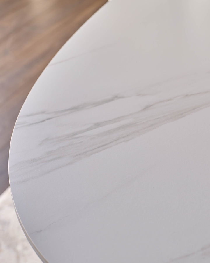 Austin ceramic fluted dining table in white, close-up detail showing curved edge and textured surface finish.