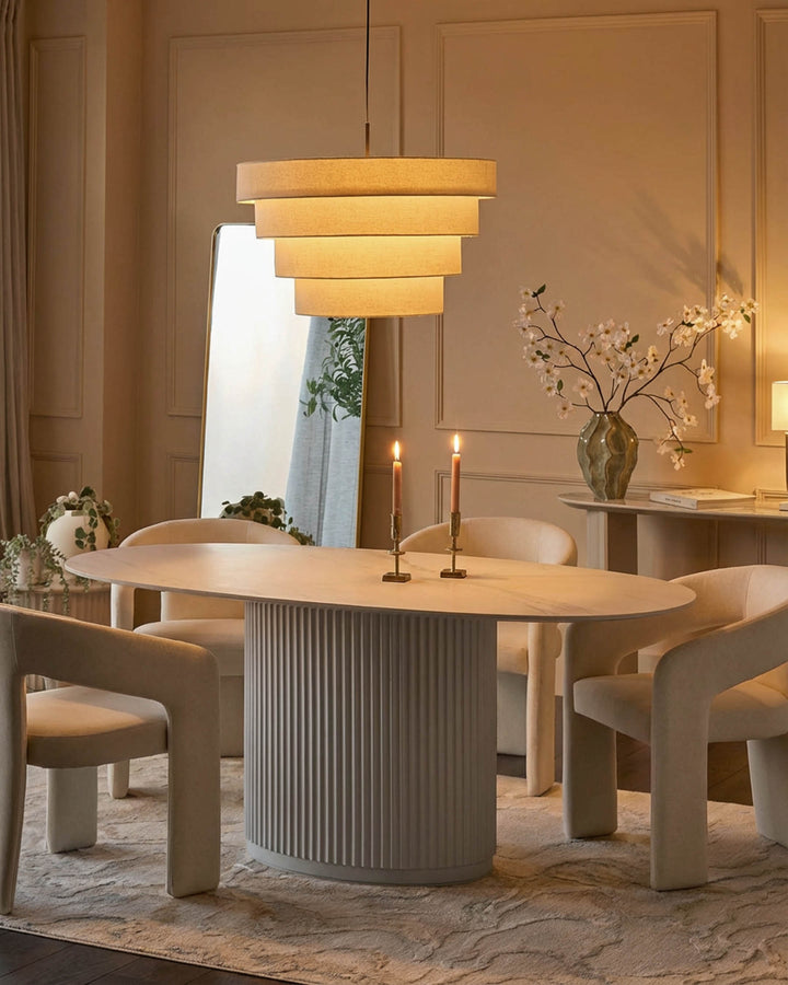 Austin ceramic fluted dining table in white with oval top and ribbed pedestal base, styled in modern dining room.