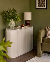 Natural ceramic compact sideboard with vertical ribbed detailing and rounded corners, styled in a modern living room setting.
