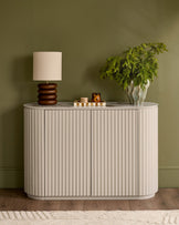 Austin Compact Sideboard in natural ceramic with vertical fluted detailing, rounded corners, and marble top surface.