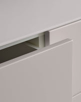 A light grey drawer of a cabinet is partially open, revealing the interior.