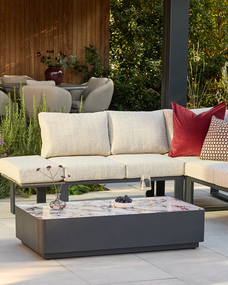 Bianco garden coffee table with black base and white Calacatta marble top, displayed in outdoor patio setting.