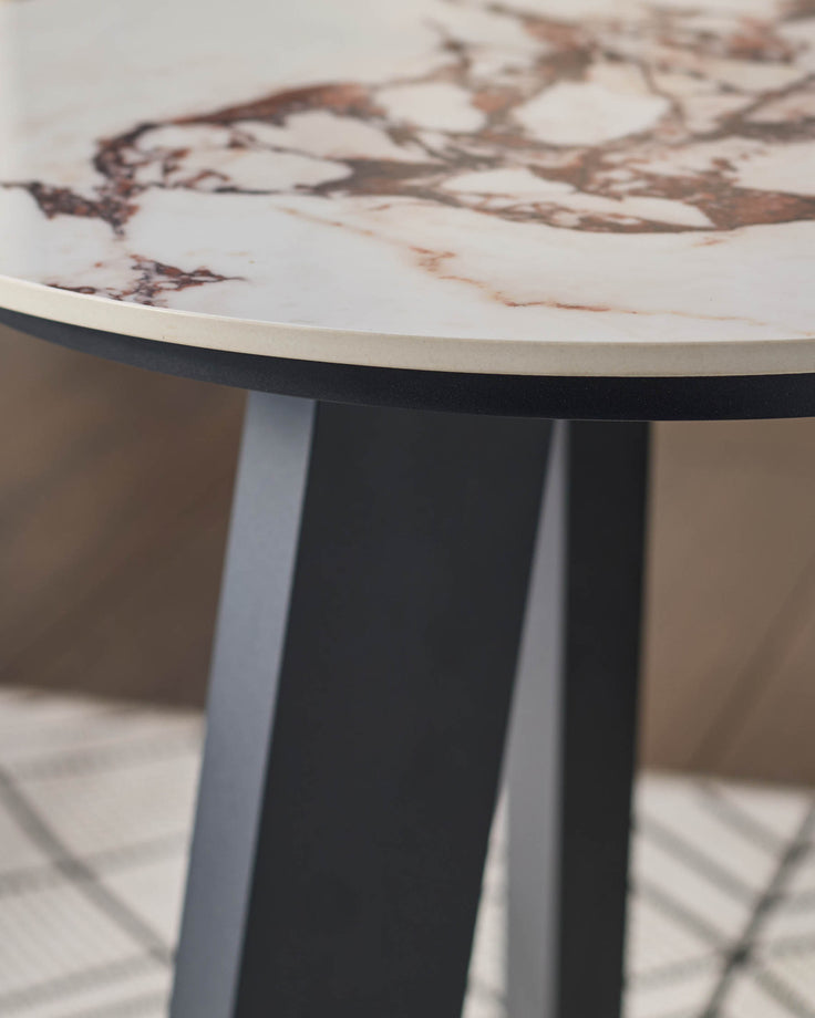 Bianco garden side table with white Calacatta marble top and black pedestal base, angled view.
