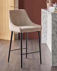 A stylish, beige bar stool with a sleek, black metal frame. Perfect for kitchen islands or home bars.
