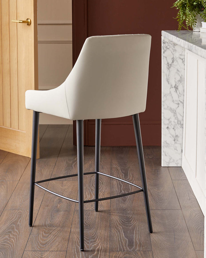 A contemporary off-white bar stool with black legs and footrest, positioned near a marble countertop and an open wooden door.