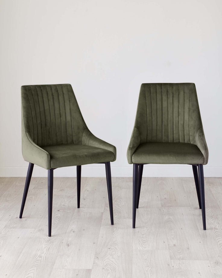 Blakely Velvet Dining Chair in Olive Green - pair shown with vertical stitching, curved backrest, and black tapered legs.