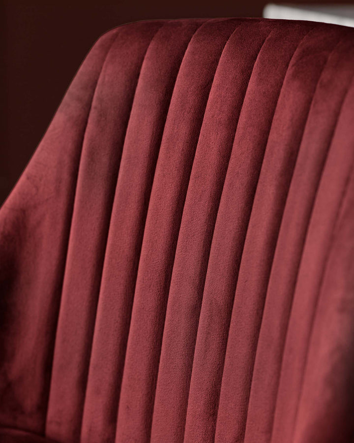 Close-up of a red velvet chair with ribbed design. Luxurious and stylish seating option for any modern living space.
