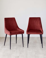 Pair of stylish, claret velvet dining chairs with sleek, black legs. Perfect for adding a touch of elegance to any dining space.