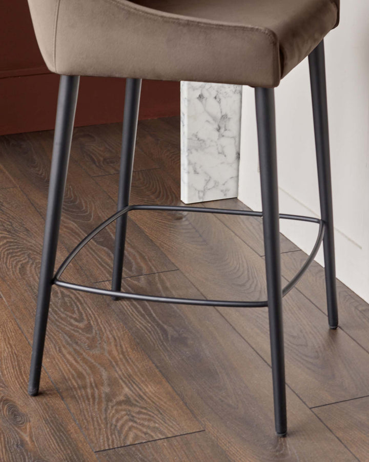 Close-up of a stylish bar stool with a brown seat and sleek black legs, perfect for modern kitchen designs.