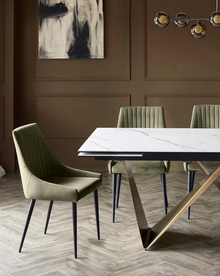 Blakely velvet dining chair in olive green with vertical stitching and black tapered legs, shown in dining setting.