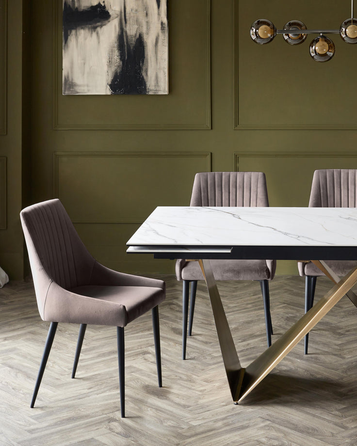 Dining set featuring a marble-top table with a modern, metallic base and complementary upholstered chairs.