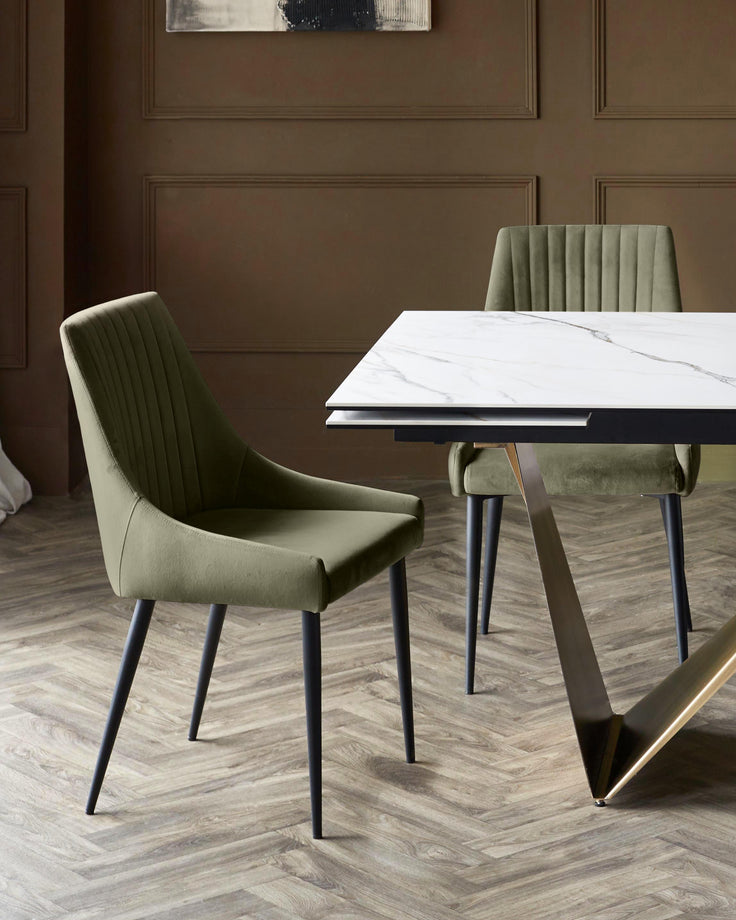 Blakely olive green velvet dining chair with vertical stitching, shown in room setting at marble table.