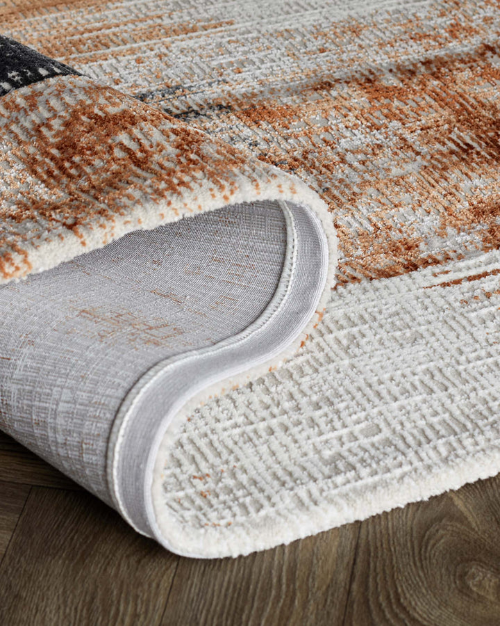 A close-up shot of a luxurious rug with abstract patterns, rolled to showcase its soft texture and high-quality craftsmanship.