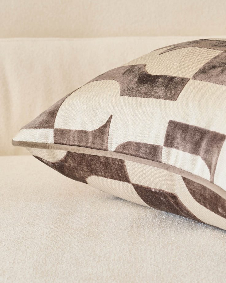 Bridget cushion in chocolate and cream checkered pattern, shown at an angle on a neutral surface.