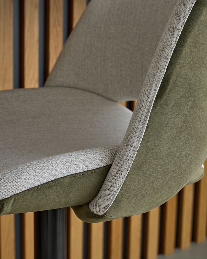 Bronwyn gas lift bar stool with natural and olive green fabric, showing seat cushion and wooden leg detail from side angle.