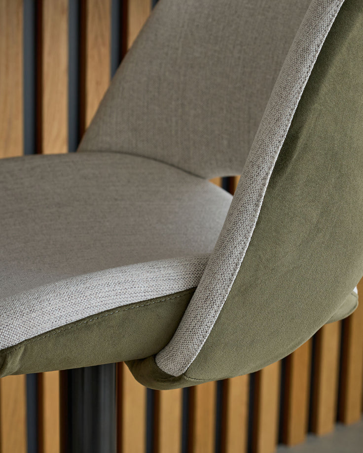 Bronwyn gas lift bar stool with natural and olive green fabric, showing seat cushion and wooden leg detail from side angle.