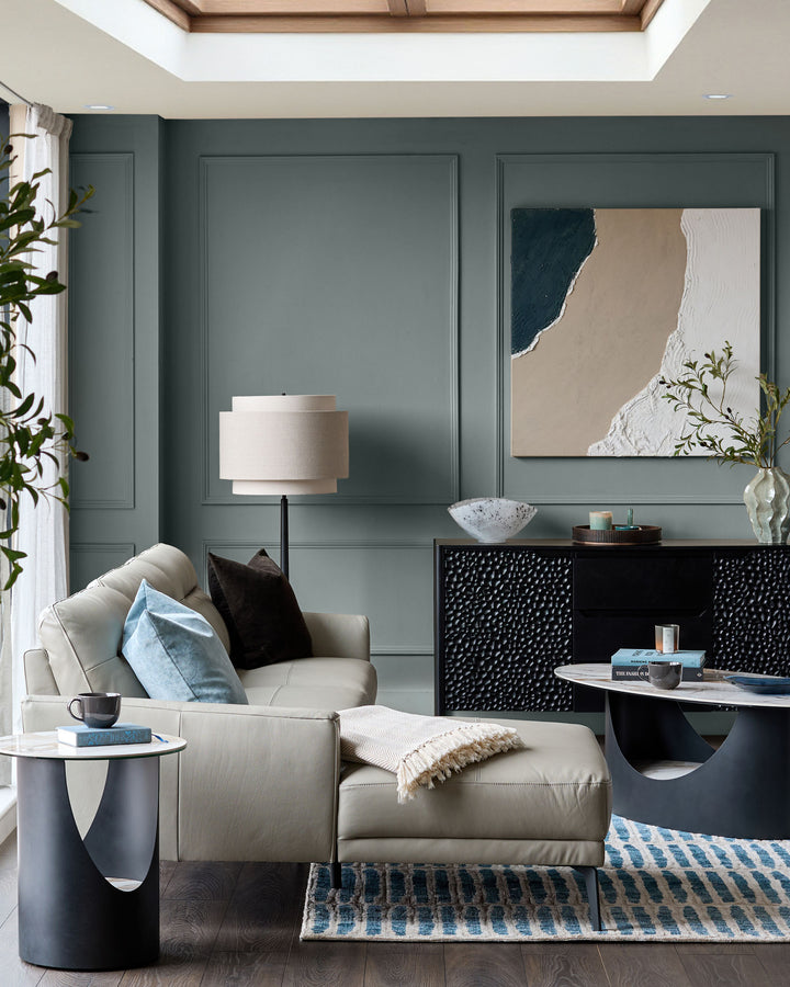 Brooks leather left-hand corner chaise sofa in light grey, shown in a styled living room setting with pillows.