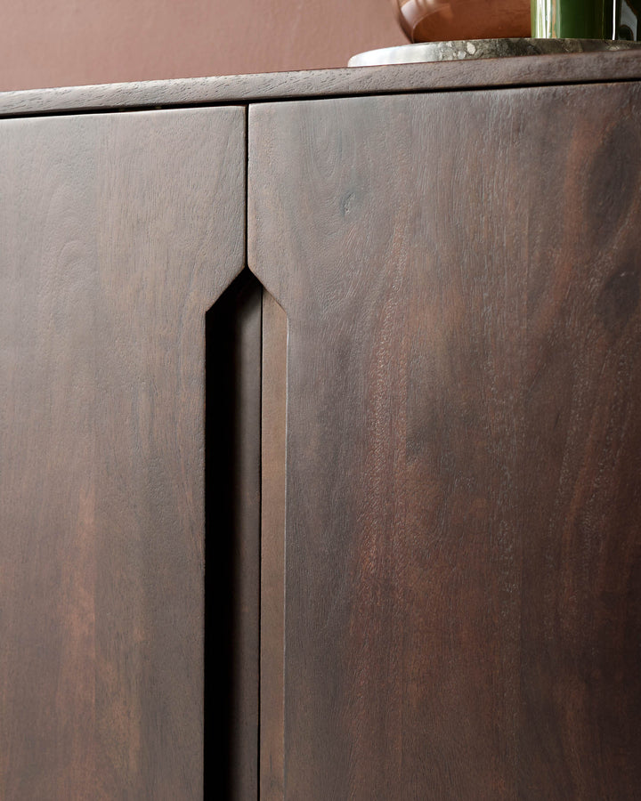 Close-up of a dark wood cabinet with a sleek, modern design, showcasing its fine grain and craftsmanship.