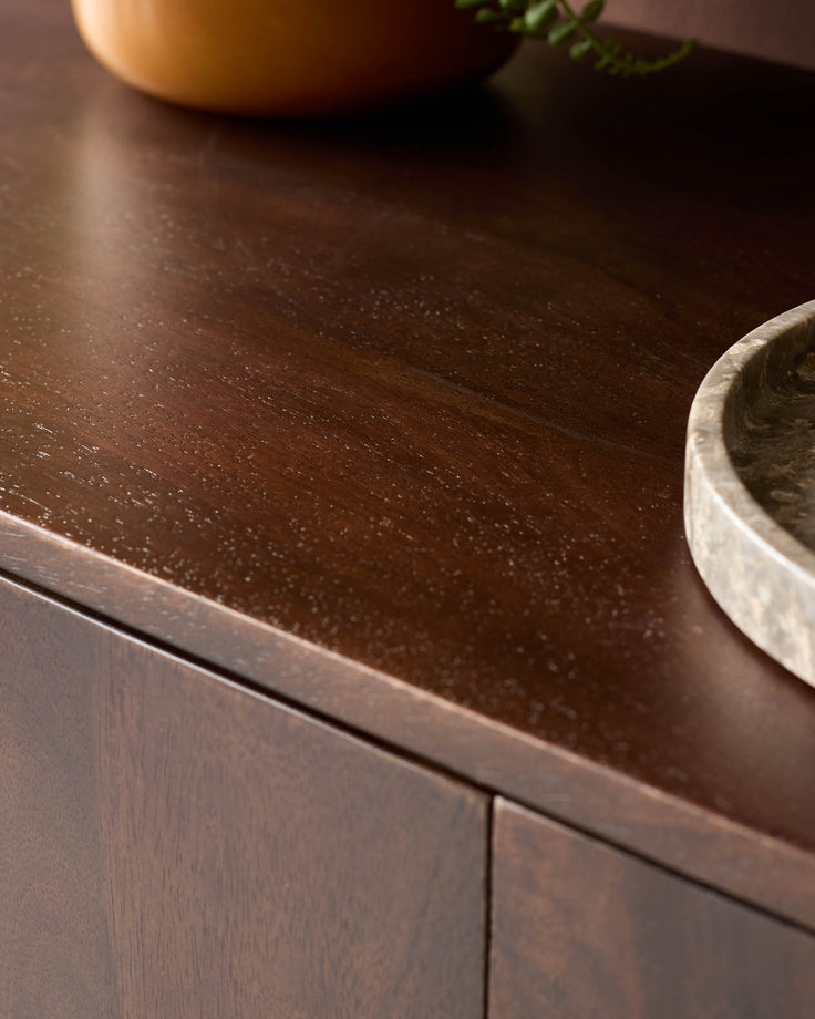 Close-up of a dark-wood cabinet, showcasing its rich grain and smooth surface.