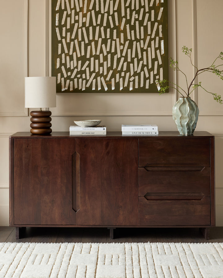 Dark mango wood sideboard with two cabinet doors and two drawers, featuring angular handles, displayed in a styled room setting.