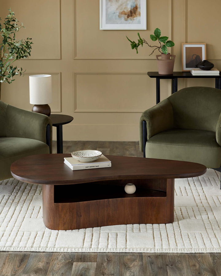 A modern living room featuring olive green armchairs, a dark wood coffee table and textured rug, creating a stylish, inviting space.