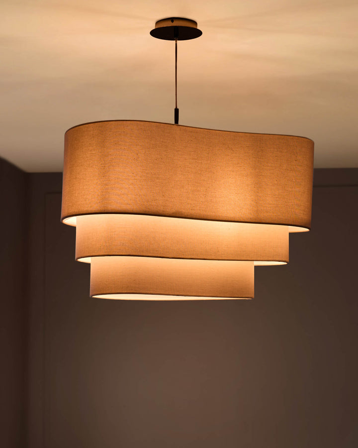 Burleigh 2-bulb pendant light with natural linen shade, featuring stacked cylindrical tiers and warm ambient lighting.